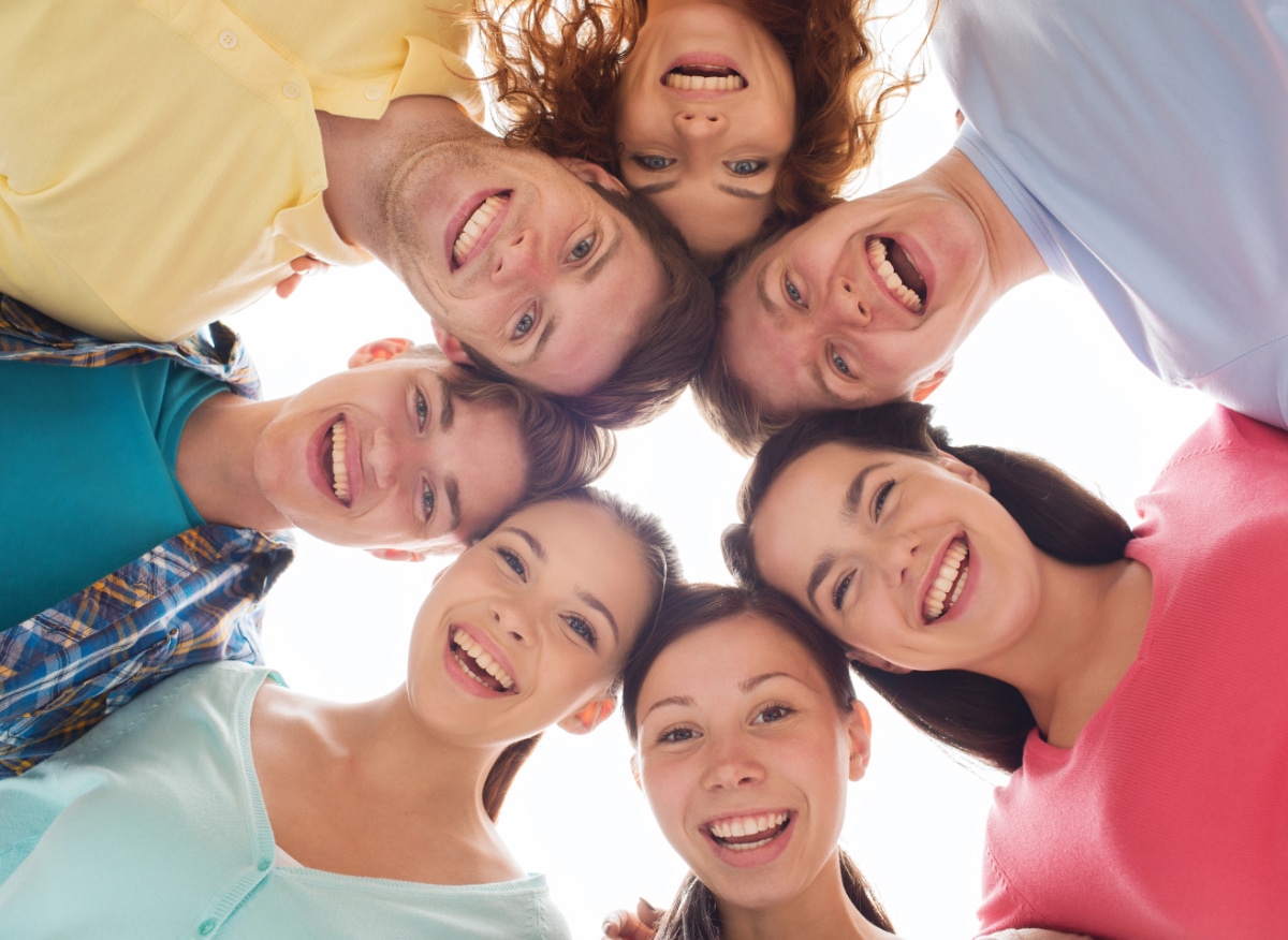 friendship, youth and people - group of smiling teenagers in circle